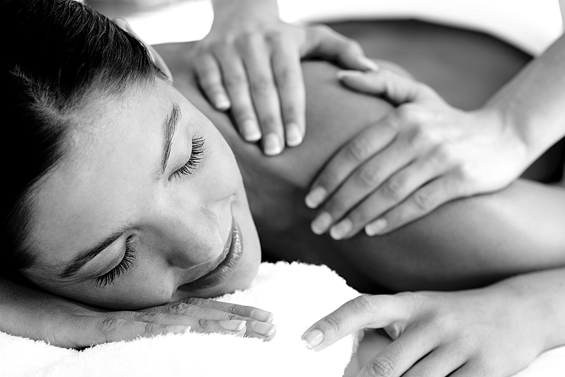 Masseuse Massaging Woman's Shoulder